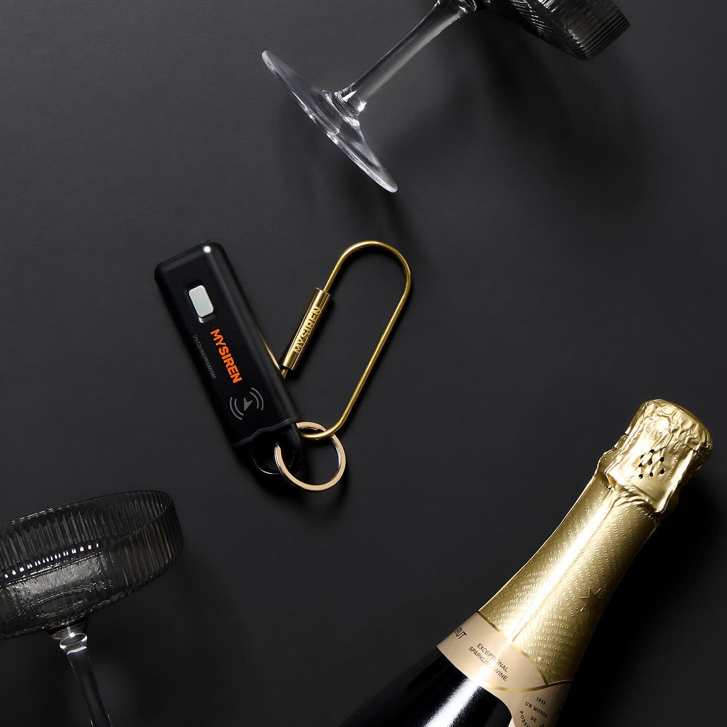 "MySiren Apple alarm size comparison showing compact portable design night out, personal safety, wine bottle, glasses"