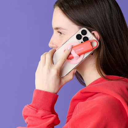 Woman holding MySiren Apple alarm while walking at night for personal safety"